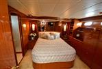 Hampton 580 Pilot House - Luxurious bedroom interior of 2009 Hampton 580 Pilot House yacht with wood finishes and cozy bed.