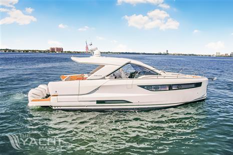 Jeanneau DB43 - 2023 Jeanneau DB43 yacht cruising on open water under a clear blue sky.