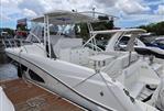 Jeanneau Leader 10.5 - 2018 Jeanneau Leader 10.5 boat docked at marina under cloudy sky.