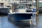 Regulator 32FS - 2002 Regulator 32FS boat docked in marina, blue hull, white interior.