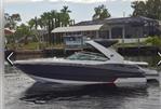 Monterey 328SS - 2015 Monterey 328SS boat on calm water near a residential dock.