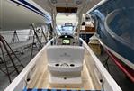 Vanquish 26 - 2021 Vanquish 26 boat interior in storage, featuring seating and console.