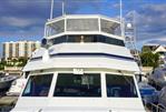 Hatteras 62 Cockpit Motor Yatch - 1990 Hatteras 62 Cockpit Motor Yacht docked at marina under blue sky.