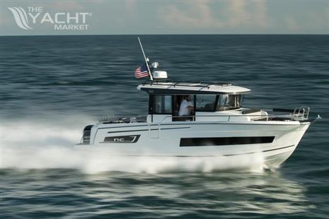 Jeanneau NC Sport 895 - 2024 Jeanneau NC Sport 895 cruising on open water, American flag flying.