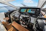 Jeanneau DB43 - 2023 Jeanneau DB43 helm with dual navigation screens and modern steering wheel.