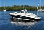 Sea Ray 260 Sundeck - 2014 Sea Ray 260 Sundeck boat cruising on a calm river.