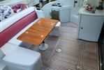 Azimut 43S - 2009 Azimut 43S yacht with teak deck, seating area, and wooden table.