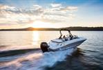 Bayliner VR5 - 2024 Bayliner VR5 boat cruising on a lake at sunset.