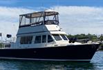 Sabreline 36 Aft Cabin Trawler - 1995 Sabreline 36 Aft Cabin Trawler on calm water, blue sky background.