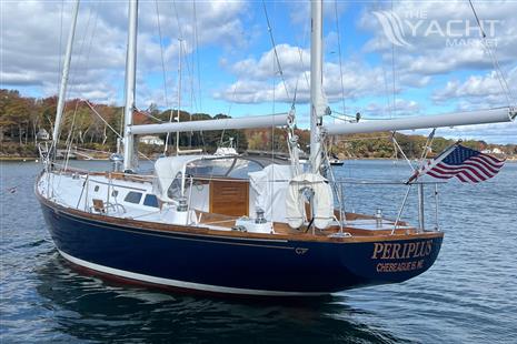 Hinckley Bermuda - 1967 Hinckley Bermuda sailboat on calm water, displaying American flag.