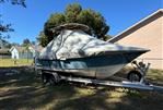 Scout 215 XSF - 2018 Scout 215 XSF boat covered on trailer in residential yard.