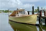 Padebco V27 Center Console - 2003 Padebco V27 Center Console boat docked on calm water.