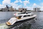 Amer 94 - Luxurious 2017 Amer 94 yacht cruising near city skyline on a sunny day.