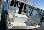 Post 43 - 1989 Post 43 boat docked at marina, featuring spacious deck and fishing equipment.