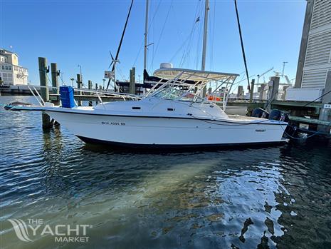 Pursuit 2800 Open - 1992 Pursuit 2800 Open boat docked at marina, clear blue sky.