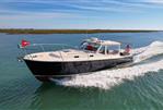 MJM 36z Downeast - 2015 MJM 36z Downeast cruising on open water, showcasing sleek design and performance.