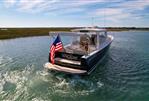 MJM 36z Downeast - 2015 MJM 36z Downeast boat cruising on a sunny day with American flag.