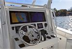 Yellowfin 36 Offshore - 2016 Yellowfin 36 Offshore boat dashboard with navigation screens and steering wheel.