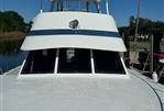 Blue Water Motor Yacht - 1982 Blue Water Motor Yacht with white deck and canopy, docked under clear blue sky.