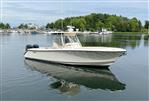 Pursuit C 280 Center Console - 2012 Pursuit C 280 Center Console boat on calm water with marina background.