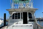 Post 43 - 1989 Post 43 boat named "Inevitable" docked at marina under clear blue sky.