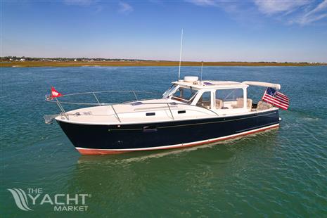 MJM 36z Downeast - 2015 MJM 36z Downeast boat cruising on calm waters under clear skies.