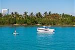 Jeanneau NC 895 S2 - 2025 Jeanneau NC 895 S2 boat on tropical waters near lush shoreline.