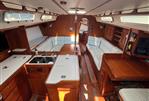 J Boats J/46 - Interior of 2004 J Boats J/46 sailboat with wood finish and white seating.