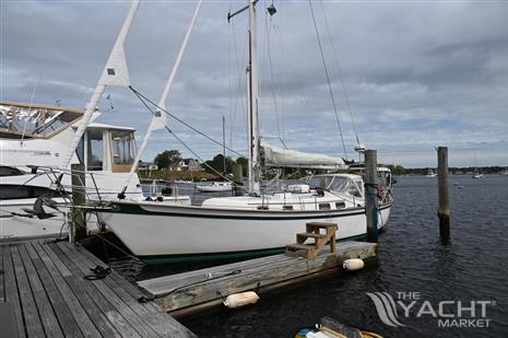 Southern Cross 39 - 1984 Southern Cross 39 sailboat docked at a marina under cloudy skies.