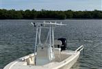 Pathfinder 2300 HPS - 2017 Pathfinder 2300 HPS boat on calm water with scenic background.