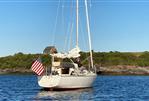 J Boats J/35 - 1984 J Boats J/35 sailboat on calm water with American flag.