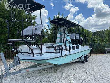 Shallow Master 270 SMC - 2024 Shallow Master 270 SMC boat on trailer, parked outdoors under cloudy sky.