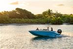 Bayliner M17 - 2024 Bayliner M17 boat cruising on a serene lake at sunset.