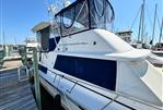 Silverton AFT CABIN - 1987 Silverton AFT CABIN yacht docked at marina under clear blue sky.