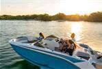 Bayliner M17 - 2024 Bayliner M17 boat cruising on a lake at sunset with passengers.