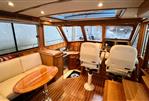 Sabre 40 Sedan - Interior of 2011 Sabre 40 Sedan yacht with wood finish and seating area.