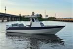 Custom Leblanc CC - Custom 2003 Leblanc CC boat on calm water near a bridge at sunset.