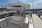 Pursuit S 280 Sport - 2011 Pursuit S 280 Sport boat docked at marina under clear sky.