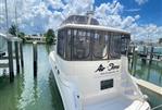 Sea Ray 420 Aft Cabin - 1998 Sea Ray 420 Aft Cabin yacht docked at marina under blue sky.