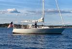 J Boats J/35 - 1984 J Boats J/35 sailboat on calm water with American flag.