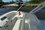 Blue Water Motor Yacht - 1982 Blue Water Motor Yacht with white seating, steering wheel, and dockside view.