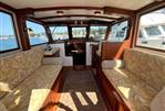 Duffy 35 Flybridge Cruiser - Interior of 1990 Duffy 35 Flybridge Cruiser with patterned seating and wood accents.