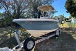 Scout 215 XSF - 2018 Scout 215 XSF boat on trailer, parked outdoors under clear sky.