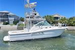 Rampage 38 Express - 2007 Rampage 38 Express boat docked near waterfront homes.