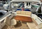 MJM 50z - 2017 MJM 50z yacht with elegant seating and wooden table at a marina.