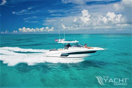 Jeanneau Leader 12.5 - 2024 Jeanneau Leader 12.5 cruising on clear turquoise waters under a bright blue sky.