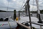 Southern Cross 39 - 1984 Southern Cross 39 sailboat docked with inflatable dinghy, overcast sky.