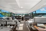 Prestige 520 - Luxurious interior of 2024 Prestige 520 yacht with modern furnishings and panoramic windows.