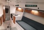 M.A.T. 1070 - 2024 M.A.T. 1070 yacht interior with modern kitchen, seating area, and wooden accents.