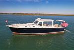 MJM 36z Downeast - 2015 MJM 36z Downeast boat cruising on calm waters under a clear blue sky.